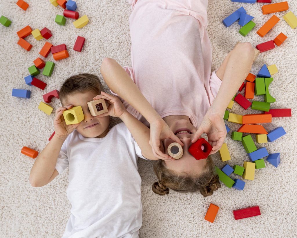 top-view-non-binary-kids-playing-with-colorful-game